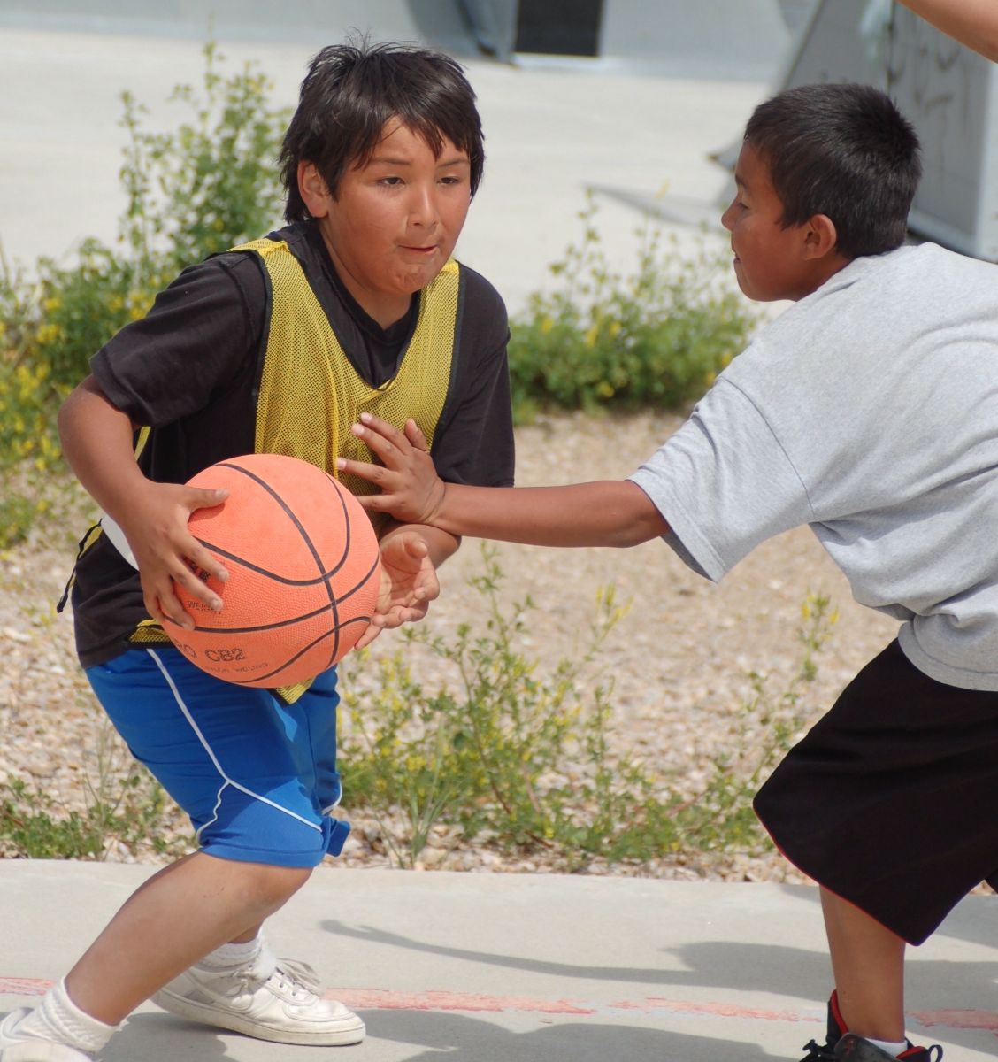 Native American youth Gabe passes the ball during one of the Unity Hoops Basketball Camp games. Photo by Christina Mullen.